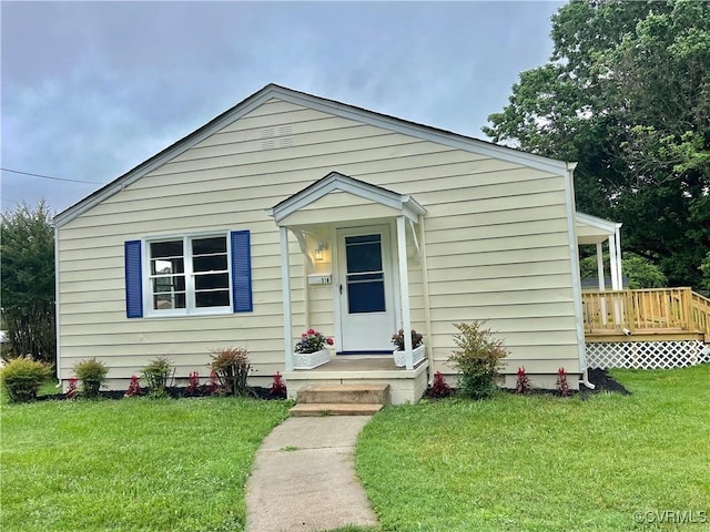 318 Youngs Rd, Petersburg, VA 23803 - bungalow-style home featuring a front lawn and a wooden deck