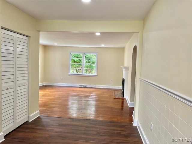 318 Youngs Rd, Petersburg, VA 23803 - unfurnished living room with dark wood-style flooring, a fireplace with flush hearth, and recessed lighting