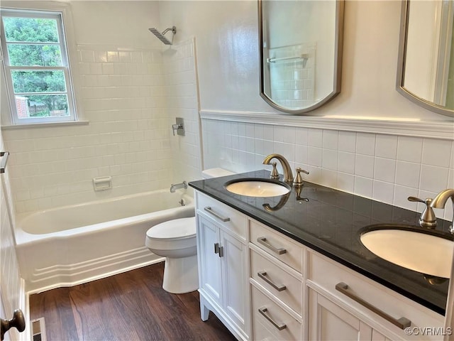 318 Youngs Rd, Petersburg, VA 23803 - bathroom featuring double vanity, shower / washtub combination, wood finished floors, and tile walls