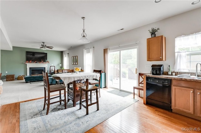 6007 Faulkner Dr, North Chesterfield, VA 23234 - dining space with light wood finished floors, a glass covered fireplace, and ceiling fan
