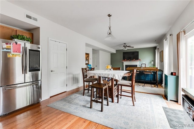 6007 Faulkner Dr, North Chesterfield, VA 23234 - dining space with ceiling fan, a fireplace, and light wood-style floors