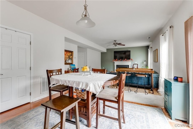 6007 Faulkner Dr, North Chesterfield, VA 23234 - dining room featuring ceiling fan, a fireplace, and light wood-style floors