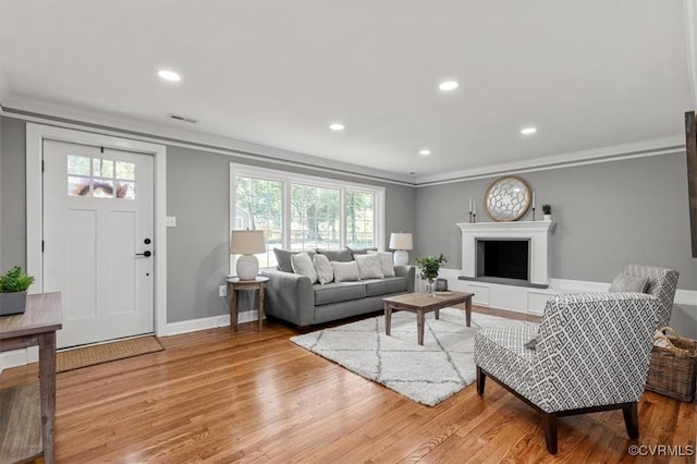 3519 Murchies Hill Rd, Richmond, VA 23234 - living area with ornamental molding, plenty of natural light, wood finished floors, recessed lighting, and a fireplace with raised hearth