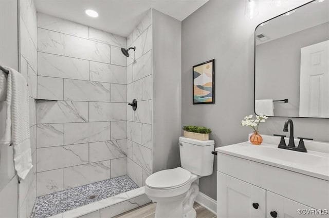 3519 Murchies Hill Rd, Richmond, VA 23234 - bathroom with vanity, a tile shower, wood finished floors, and recessed lighting