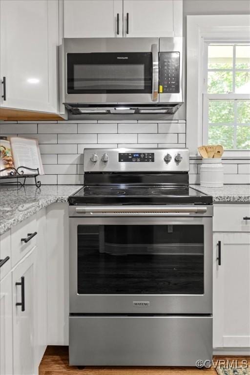 3519 Murchies Hill Rd, Richmond, VA 23234 - kitchen with appliances with stainless steel finishes, white cabinetry, and backsplash