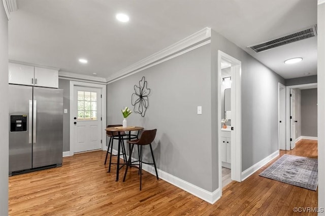 3519 Murchies Hill Rd, Richmond, VA 23234 - kitchen with stainless steel fridge, light wood-type flooring, crown molding, white cabinetry, and recessed lighting