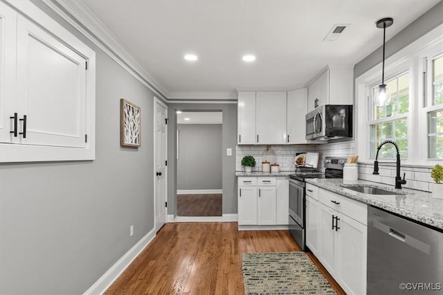 3519 Murchies Hill Rd, Richmond, VA 23234 - kitchen with appliances with stainless steel finishes, tasteful backsplash, light stone counters, white cabinetry, and crown molding