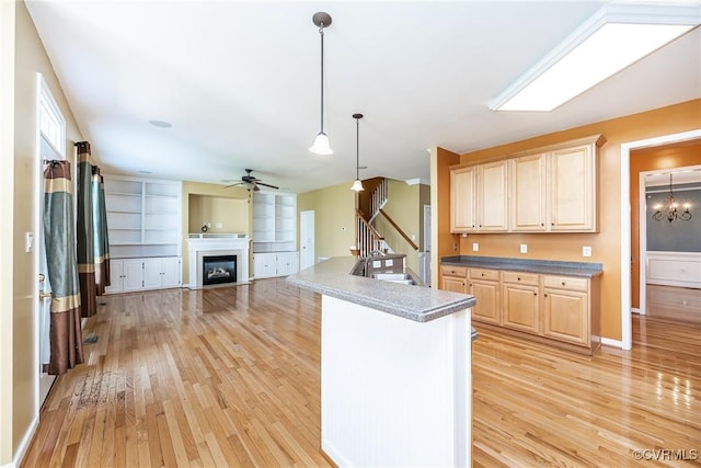 11420 Willows Green Way, Glen Allen, VA 23059 - kitchen featuring light wood-style floors, a ceiling fan, a fireplace, decorative light fixtures, and open floor plan