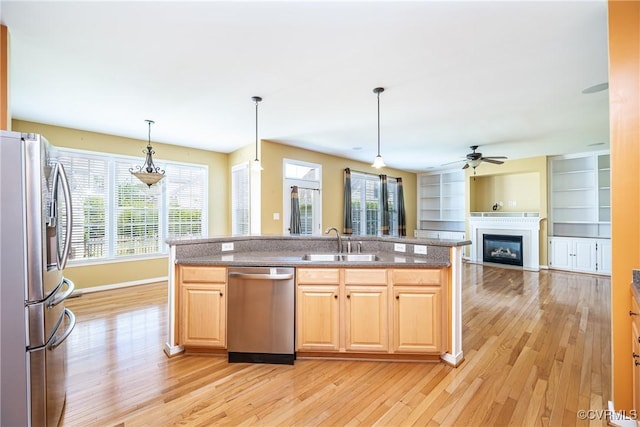 11420 Willows Green Way, Glen Allen, VA 23059 - kitchen with stainless steel appliances, a fireplace, light wood finished floors, a ceiling fan, and open floor plan