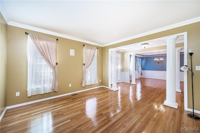 11420 Willows Green Way, Glen Allen, VA 23059 - spare room featuring decorative columns, light wood finished floors, a chandelier, crown molding, and a wainscoted wall