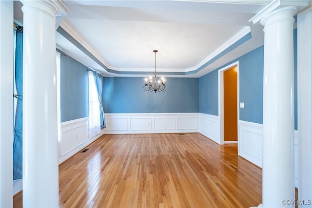 11420 Willows Green Way, Glen Allen, VA 23059 - unfurnished dining area featuring decorative columns, light wood finished floors, a raised ceiling, a chandelier, and a wainscoted wall