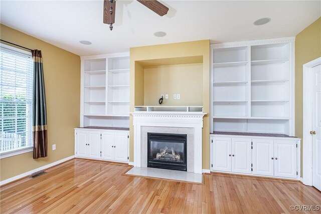 11420 Willows Green Way, Glen Allen, VA 23059 - unfurnished living room with ceiling fan, light wood-style flooring, built in shelves, and a glass covered fireplace