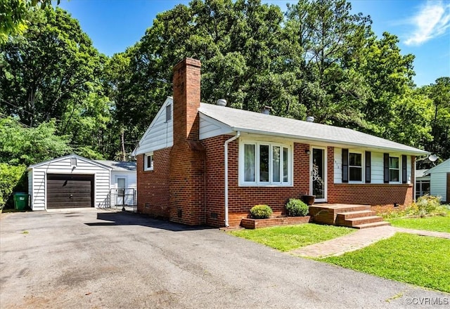 2412 Omega Rd, Henrico, VA 23228 - view of front facade featuring a chimney, an outbuilding, brick siding, and a detached garage