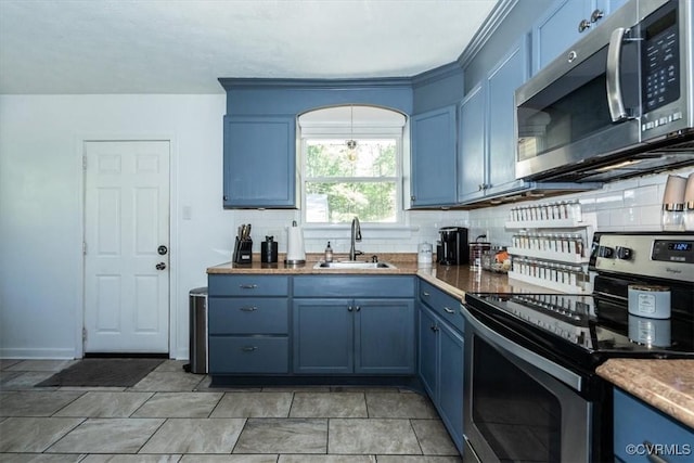 2412 Omega Rd, Henrico, VA 23228 - kitchen featuring stainless steel appliances, blue cabinetry, and tasteful backsplash