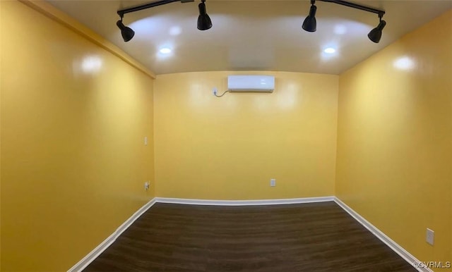 2412 Omega Rd, Henrico, VA 23228 - unfurnished room with an AC wall unit, dark wood finished floors, and rail lighting