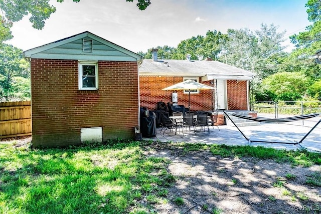 2412 Omega Rd, Henrico, VA 23228 - rear view of house featuring a patio and brick siding