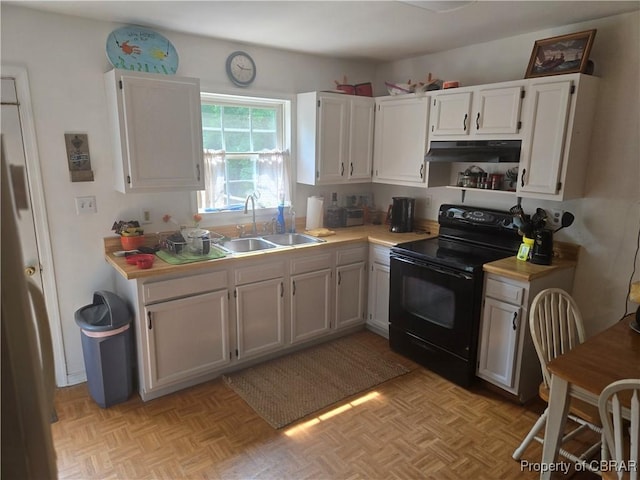 231 Fox Point Rd, Reedville, VA 22539 - kitchen with electric range, light countertops, under cabinet range hood, and white cabinets