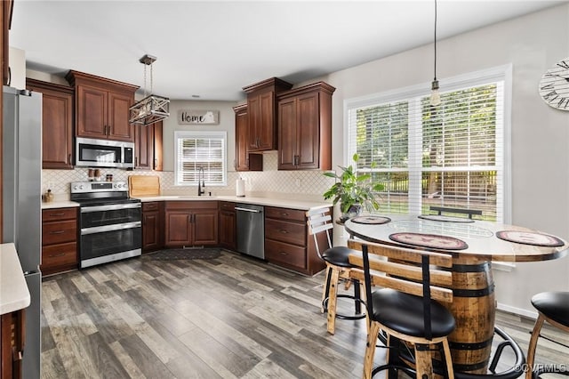 2925 Mariners Pl, Midlothian, VA 23112 - kitchen featuring appliances with stainless steel finishes, light countertops, healthy amount of natural light, and dark wood-style floors