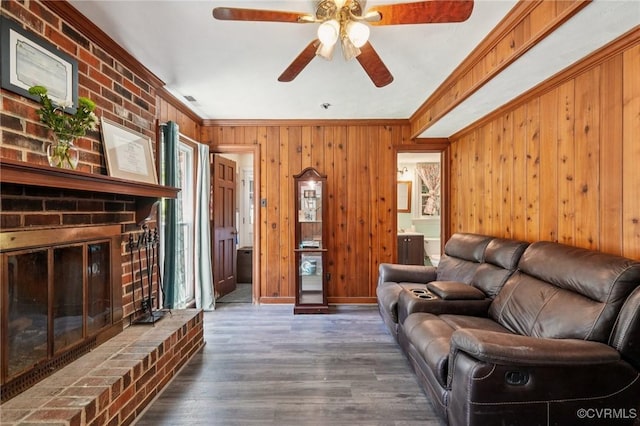 301 Perth Ln, Sandston, VA 23150 - living room with wood finished floors, wood walls, ornamental molding, a ceiling fan, and a fireplace
