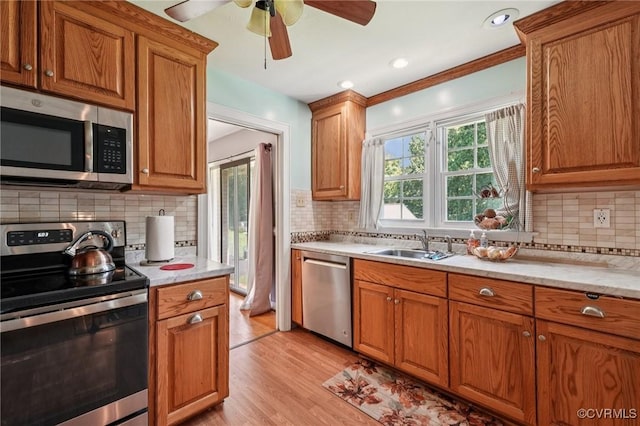 301 Perth Ln, Sandston, VA 23150 - kitchen with stainless steel appliances, tasteful backsplash, brown cabinetry, and ornamental molding