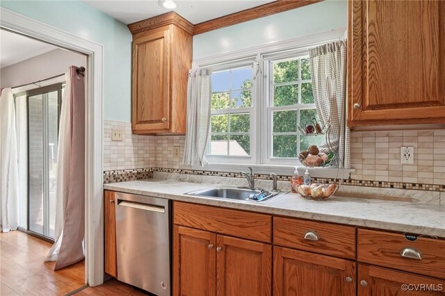 301 Perth Ln, Sandston, VA 23150 - kitchen with dishwasher, tasteful backsplash, light wood-style flooring, and brown cabinets