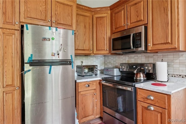301 Perth Ln, Sandston, VA 23150 - kitchen with appliances with stainless steel finishes, tasteful backsplash, and brown cabinets