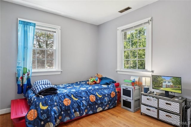 301 Perth Ln, Sandston, VA 23150 - bedroom with multiple windows and wood finished floors