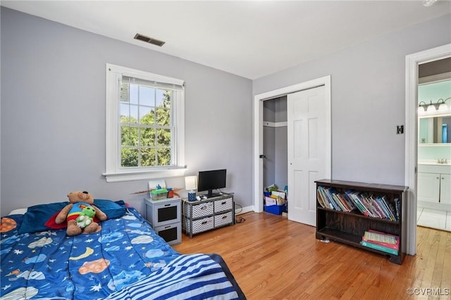 301 Perth Ln, Sandston, VA 23150 - bedroom with wood finished floors, a closet, and ensuite bathroom