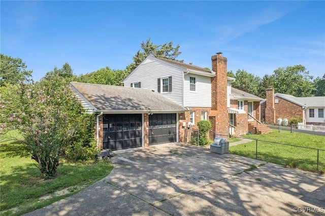 301 Perth Ln, Sandston, VA 23150 - view of front of house with brick siding, a chimney, concrete driveway, and a garage
