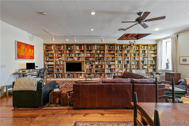 22 N Sycamore St, Petersburg, VA 23803 - living room with hardwood / wood-style flooring, a ceiling fan, and bookshelves