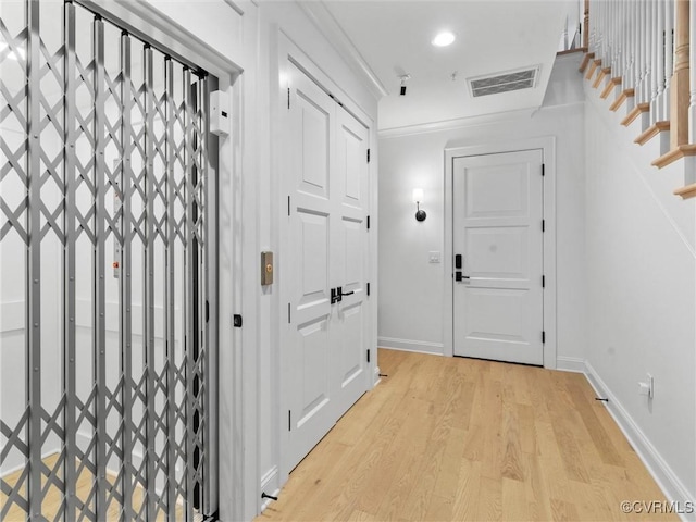 511 Libbie Ave Unit C, Richmond, VA 23226 - hallway featuring light wood-style floors, stairway, and recessed lighting