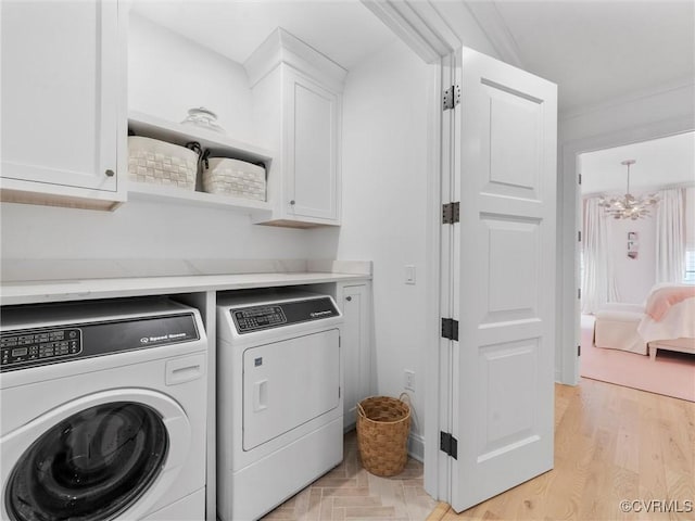 511 Libbie Ave Unit C, Richmond, VA 23226 - washroom with cabinet space, washing machine and dryer, a chandelier, and light wood finished floors