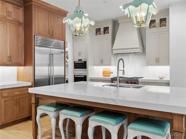 511 Libbie Ave Unit C, Richmond, VA 23226 - kitchen featuring a chandelier, custom range hood, appliances with stainless steel finishes, glass insert cabinets, and recessed lighting