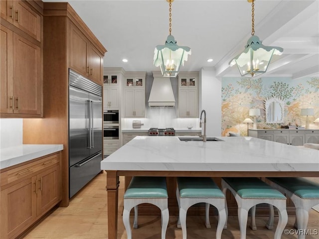 511 Libbie Ave Unit C, Richmond, VA 23226 - kitchen with stainless steel appliances, a chandelier, custom exhaust hood, a kitchen bar, and backsplash