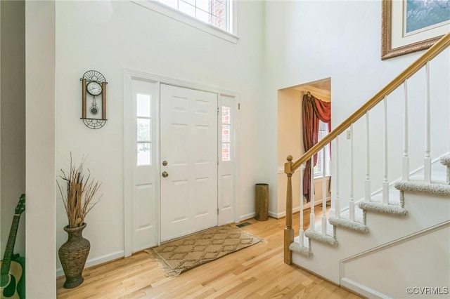 1413 N Mill Point Ct, Suffolk, VA 23434 - entryway featuring stairway, a high ceiling, and wood finished floors