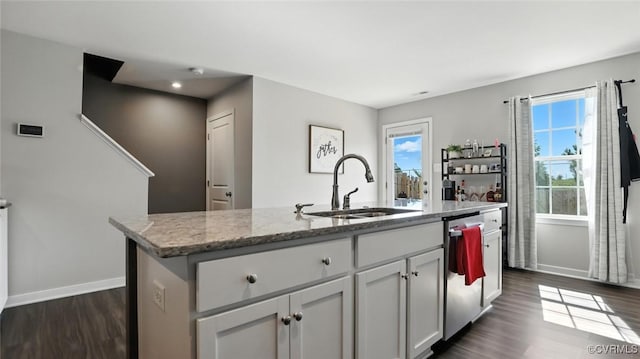 1954 Kennington Park Rd, Aylett, VA 23009 - kitchen featuring dishwasher, light stone counters, dark wood finished floors, an island with sink, and white cabinetry