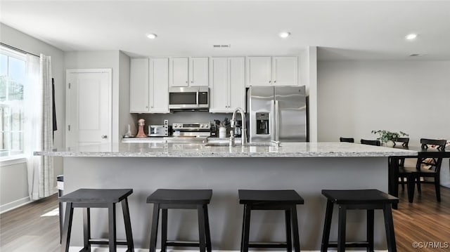 1954 Kennington Park Rd, Aylett, VA 23009 - kitchen featuring stainless steel appliances, dark wood-type flooring, a breakfast bar area, white cabinetry, and recessed lighting