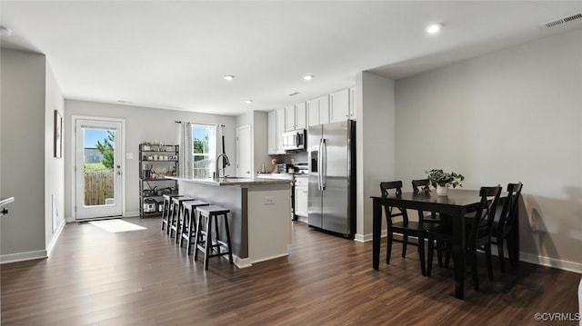 1954 Kennington Park Rd, Aylett, VA 23009 - kitchen with stainless steel appliances, a kitchen island with sink, dark wood-style flooring, white cabinetry, and recessed lighting