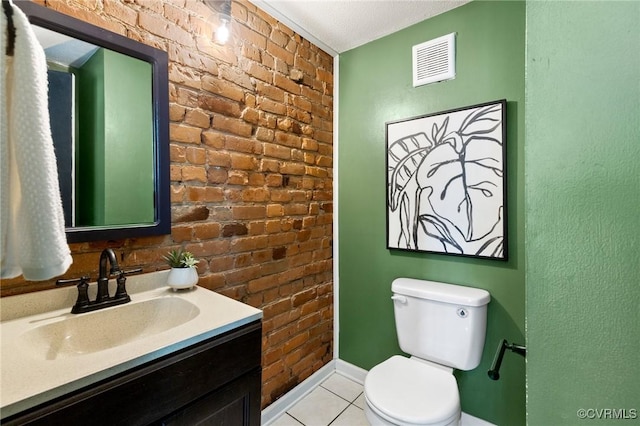 118 N Lombardy St, Richmond, VA 23220 - bathroom with brick wall, vanity, and tile patterned floors