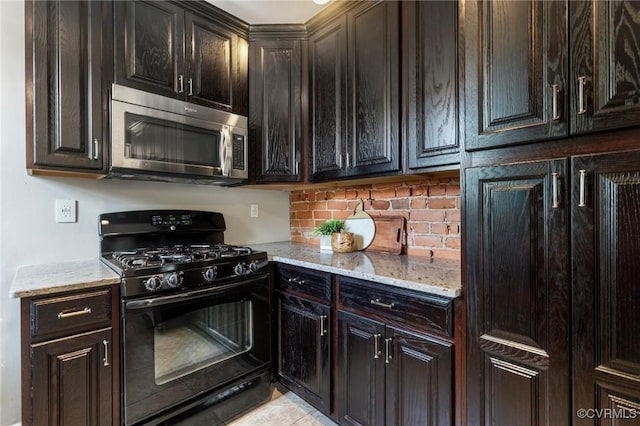 118 N Lombardy St, Richmond, VA 23220 - kitchen featuring black gas stove, stainless steel microwave, light stone countertops, backsplash, and light tile patterned floors