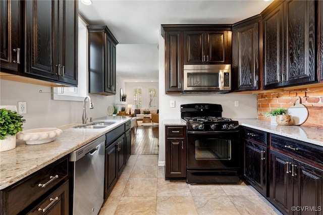 118 N Lombardy St, Richmond, VA 23220 - kitchen featuring stainless steel appliances, backsplash, light stone counters, dark brown cabinets, and light tile patterned flooring