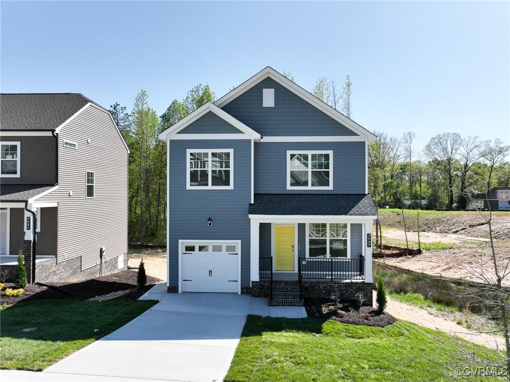 7937 Lyndale Dr, Chesterfield, VA 23235 - craftsman-style home featuring a porch, an attached garage, concrete driveway, and a front lawn