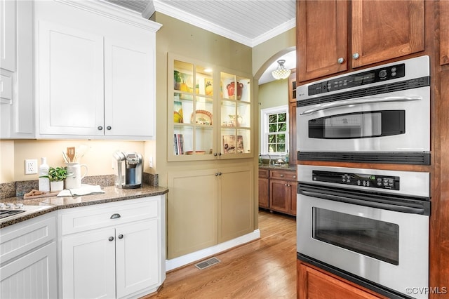 8707 Taylor Landing Pl, Chesterfield, VA 23838 - kitchen featuring ornamental molding, stainless steel double oven, light wood-style floors, white cabinetry, and light stone countertops