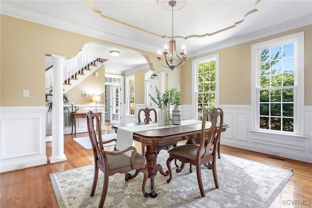 8707 Taylor Landing Pl, Chesterfield, VA 23838 - dining room with a wainscoted wall, light wood-type flooring, a decorative wall, crown molding, and a chandelier