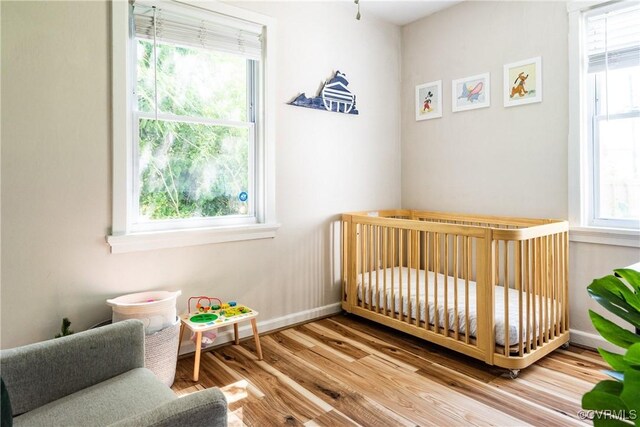 3712 Moody Ave, Richmond, VA 23225 - bedroom with wood finished floors and a crib