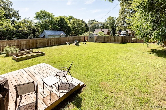 3712 Moody Ave, Richmond, VA 23225 - fenced backyard featuring a storage shed, a wooden deck, and a vegetable garden