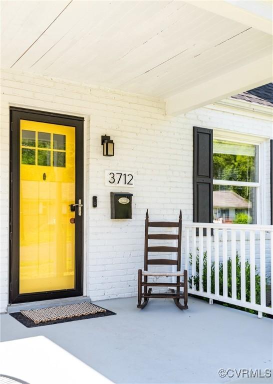 3712 Moody Ave, Richmond, VA 23225 - property entrance with a porch and brick siding
