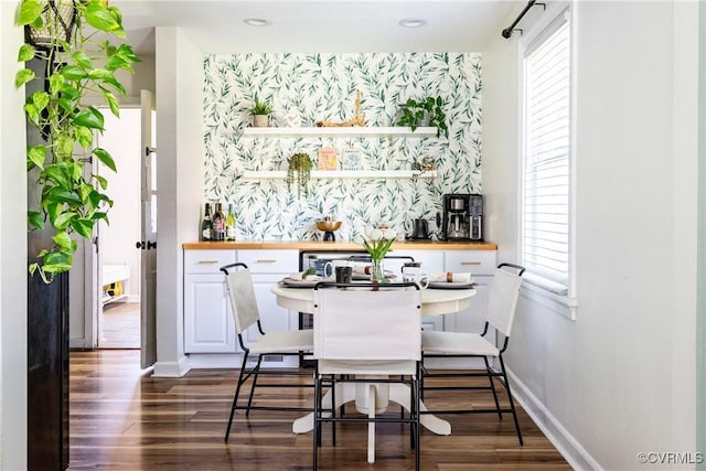 3712 Moody Ave, Richmond, VA 23225 - dining room with dark wood-type flooring, an accent wall, and wallpapered walls