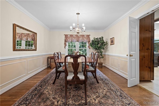 14230 Netherfield Dr, Midlothian, VA 23113 - dining area with a chandelier, wood finished floors, ornamental molding, a decorative wall, and wainscoting