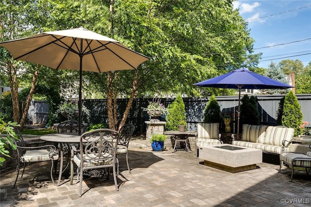 5005 Caledonia Rd, Richmond, VA 23225 - fenced backyard with outdoor dining area, a patio, and an outdoor living space with a fire pit
